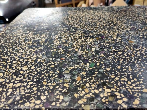Photo of the polished table surface. The coloured quartz bits are showing up really well. It's quite hard to photo under artificial lighting and as a result the top left corner of the table isn't really visible because it's reflecting too much light