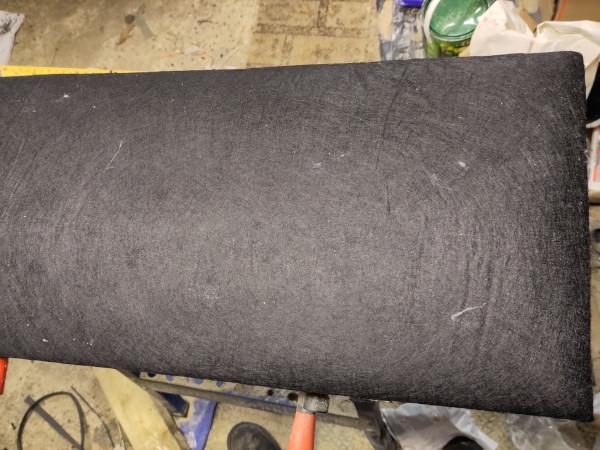 A photo of the front of the upholstered board. It's fairly clear that it's well cushioned/padded because the material sort of tapers to reach the edge