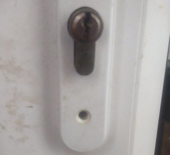 uPVC door handle with retaining screw removed
